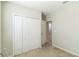 Carpeted bedroom featuring a double door closet, and an additional entry to other rooms in the house at 547 Sardinia Cir, Davenport, FL 33837