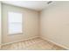 A standard bedroom with neutral walls and carpet, featuring a bright window with white blinds at 547 Sardinia Cir, Davenport, FL 33837