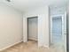 Standard bedroom with neutral walls and carpet, featuring a closet with shelving, and an extra room at 547 Sardinia Cir, Davenport, FL 33837