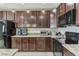 The kitchen features dark cabinetry with granite countertops and stainless appliances at 547 Sardinia Cir, Davenport, FL 33837
