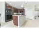 Kitchen featuring dark cabinets, granite countertops and a central island with a sink at 547 Sardinia Cir, Davenport, FL 33837
