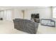 Spacious living area featuring a comfortable sofa, neutral paint, and tile flooring at 547 Sardinia Cir, Davenport, FL 33837