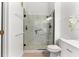 Elegant bathroom with a glass-enclosed shower featuring marble-look tile and modern fixtures at 539 Water St # 539, Kissimmee, FL 34747