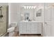 Well-lit bathroom with white cabinetry, large mirror, and shower with glass door at 539 Water St # 539, Kissimmee, FL 34747