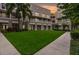 Beautiful courtyard with green grass and sidewalks surrounded by apartments with balconies at 539 Water St # 539, Kissimmee, FL 34747