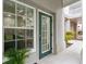 Exterior doorway with adjacent window, potted plant and view of the building's courtyard at 539 Water St # 539, Kissimmee, FL 34747