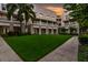 Charming exterior with lush lawn, palm trees, and classic architecture, perfect for a serene living environment at 539 Water St # 539, Kissimmee, FL 34747