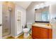 Functional bathroom with a walk-in shower, a toilet, and a vanity with a sink and storage at 5494 Paradise Cay Cir, Kissimmee, FL 34746