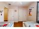Bright bedroom with two beds, wood floors, ceiling fan, and Disney themed decor at 5494 Paradise Cay Cir, Kissimmee, FL 34746