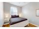 Cozy bedroom with natural light, hardwood floors, and a comfortable bed with stylish gray bedding at 5494 Paradise Cay Cir, Kissimmee, FL 34746
