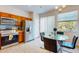 Modern kitchen with stainless steel appliances, tile flooring, and a glass dining table near a bright window at 5494 Paradise Cay Cir, Kissimmee, FL 34746