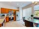 Modern kitchen with stainless steel appliances, tile flooring, and a glass dining table near a bright window at 5494 Paradise Cay Cir, Kissimmee, FL 34746