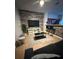 Stylish living room featuring a modern accent wall, a comfortable sofa, and a view of the kitchen area at 5494 Paradise Cay Cir, Kissimmee, FL 34746