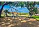 Community playground with mature shade trees provides a cool area for to play at 5494 Paradise Cay Cir, Kissimmee, FL 34746