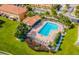 Aerial view of a community pool surrounded by lush landscaping, a perfect retreat for relaxation and recreation at 5494 Paradise Cay Cir, Kissimmee, FL 34746