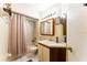 Functional bathroom with shower-tub combination, vanity, mirror, and good lighting at 62 Lakepointe Cir, Kissimmee, FL 34743