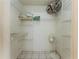 Walk-in closet with tiled floor and adjustable wire shelving for organized storage space at 62 Lakepointe Cir, Kissimmee, FL 34743