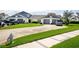 Well-maintained townhome featuring attached garages, manicured lawn and long driveway at 62 Lakepointe Cir, Kissimmee, FL 34743