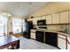 Functional kitchen featuring tiled floors, modern appliances, and natural light at 62 Lakepointe Cir, Kissimmee, FL 34743