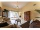 Bright living room with tile floors, ceiling fan, comfortable sofas, and sliding doors to the outdoor space at 62 Lakepointe Cir, Kissimmee, FL 34743