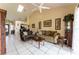 Open-concept living room with tile floors, ample natural light, comfortable seating, and stylish decor at 62 Lakepointe Cir, Kissimmee, FL 34743