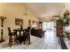 Cozy living room with tiled floors, comfortable sofas, dining table and chairs, and sliding doors to the outdoors at 62 Lakepointe Cir, Kissimmee, FL 34743