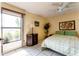 Sunny main bedroom with tile floors, ceiling fan, a large window with a lake view, and ample space at 62 Lakepointe Cir, Kissimmee, FL 34743