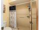 Accessible shower featuring grab bars and a shower chair, ensuring safety and convenience at 62 Lakepointe Cir, Kissimmee, FL 34743