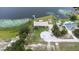 A beautiful lakefront property with a dock, outbuilding, mature trees, and solar panels from above at 124 Pangola Dr, Winter Haven, FL 33880