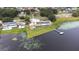 Beautiful aerial view shows the lakefront home, expansive yard, private dock, and neighboring homes at 124 Pangola Dr, Winter Haven, FL 33880