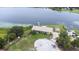 Aerial view of the lakefront home showcasing mature landscaping and a private dock on the water at 124 Pangola Dr, Winter Haven, FL 33880