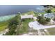 Aerial view shows the lakefront property with dock, outbuilding, mature landscaping and solar panels at 124 Pangola Dr, Winter Haven, FL 33880