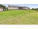 Extensive backyard featuring ample green space, ideal for recreation and outdoor activities at 124 Pangola Dr, Winter Haven, FL 33880