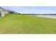 Expansive backyard with lush grass, providing a serene setting for outdoor living and relaxation at 124 Pangola Dr, Winter Haven, FL 33880