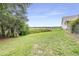 A spacious backyard provides plenty of room to relax and play with a peaceful backdrop at 124 Pangola Dr, Winter Haven, FL 33880