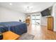 Spacious bedroom featuring wood floors, ceiling fan, and sliding glass doors to the lake at 124 Pangola Dr, Winter Haven, FL 33880