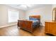 Charming bedroom with wood floors, a ceiling fan, and a large window with blinds at 124 Pangola Dr, Winter Haven, FL 33880