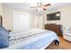 Bedroom featuring wood floors, a ceiling fan, large closet, and a queen bed at 124 Pangola Dr, Winter Haven, FL 33880