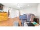 This bedroom boasts wood floors, neutral walls, a ceiling fan, and closet access at 124 Pangola Dr, Winter Haven, FL 33880