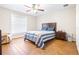 Bedroom featuring wood floors, a ceiling fan, a large window, and a queen bed at 124 Pangola Dr, Winter Haven, FL 33880