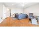 Bright bedroom with wood floors, ceiling fan, and an accent chair with ottoman at 124 Pangola Dr, Winter Haven, FL 33880