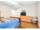 Bedroom with wood floors, a ceiling fan, a dresser, and a mounted television at 124 Pangola Dr, Winter Haven, FL 33880