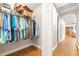 Walk-in closet featuring ample hanging space, storage shelves, and easy access to the main hallway at 124 Pangola Dr, Winter Haven, FL 33880