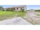 Tan home on a large lot with garage and shop in the rear at 124 Pangola Dr, Winter Haven, FL 33880