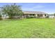 Ranch style home with large, green front yard and charming covered front porch at 124 Pangola Dr, Winter Haven, FL 33880