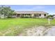 Ranch style home with large, green front yard and charming covered front porch at 124 Pangola Dr, Winter Haven, FL 33880