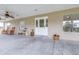 View of front door and covered porch with fans, rocking chairs, and decor at 124 Pangola Dr, Winter Haven, FL 33880