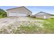 Detached two-car garage with ample parking space and additional storage shed on a gravel driveway at 124 Pangola Dr, Winter Haven, FL 33880
