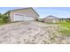 Two-car garage, storage shed and large gravel driveway with room to park multiple vehicles at 124 Pangola Dr, Winter Haven, FL 33880