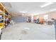 Spacious garage with high ceilings, shelving, and room for multiple cars at 124 Pangola Dr, Winter Haven, FL 33880